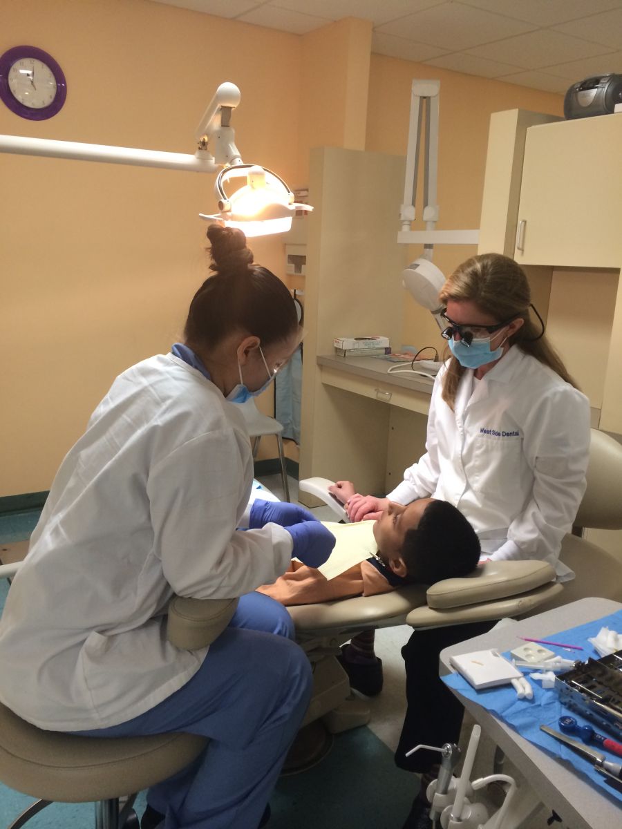 Dr. Sobieraj performing dental procedure at Give Kids a Smile